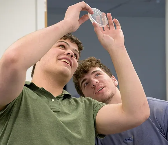 Two science students examining a sample